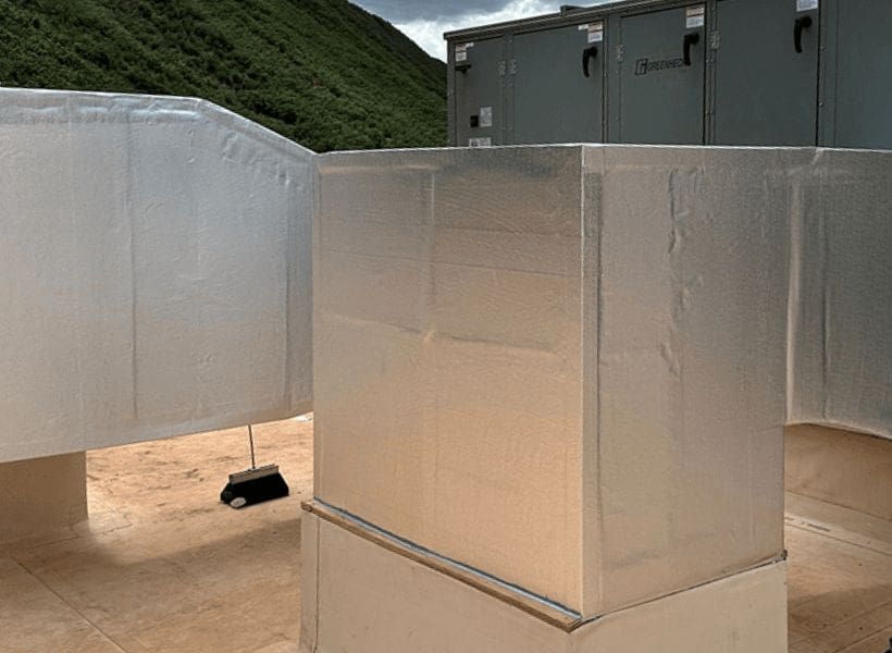 Insulated ductwork and electrical boxes outdoors.
