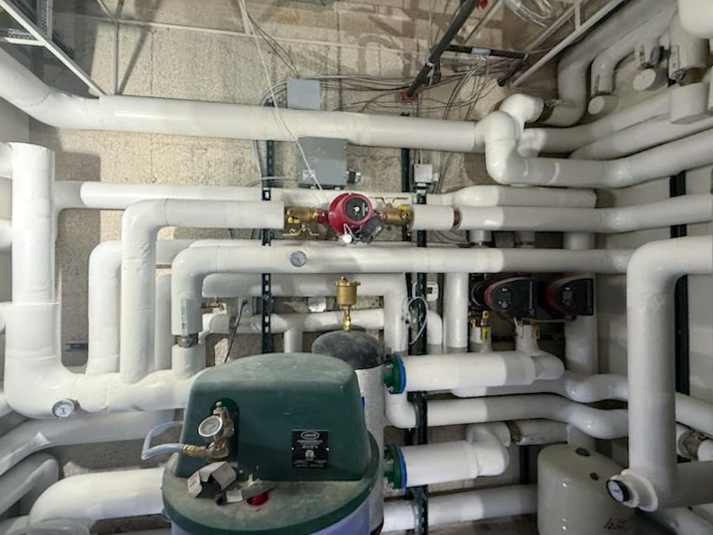 Complex network of insulated pipes in basement.