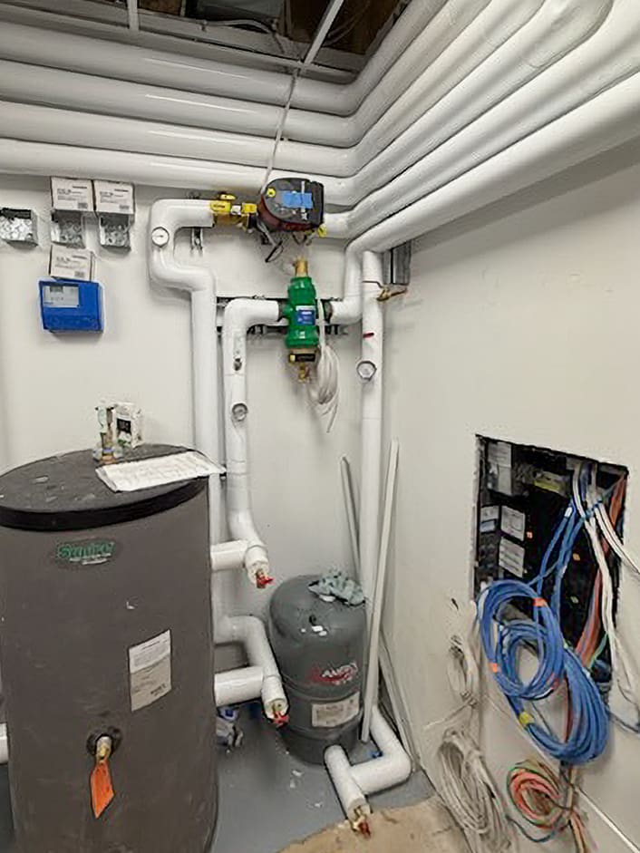 Boiler room with pipes and equipment.